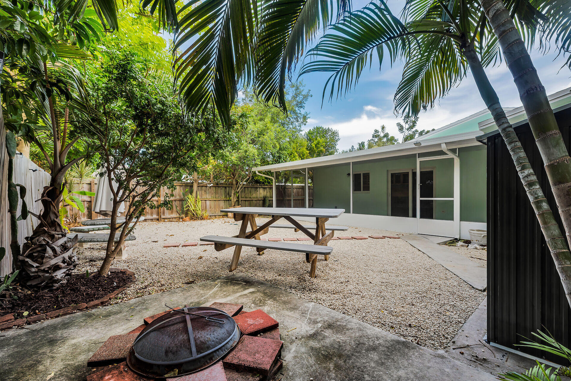 535 Plante Street Key Largo, FL 33037 - Photo 9 of 47 a view of a chair and tables in the patio
