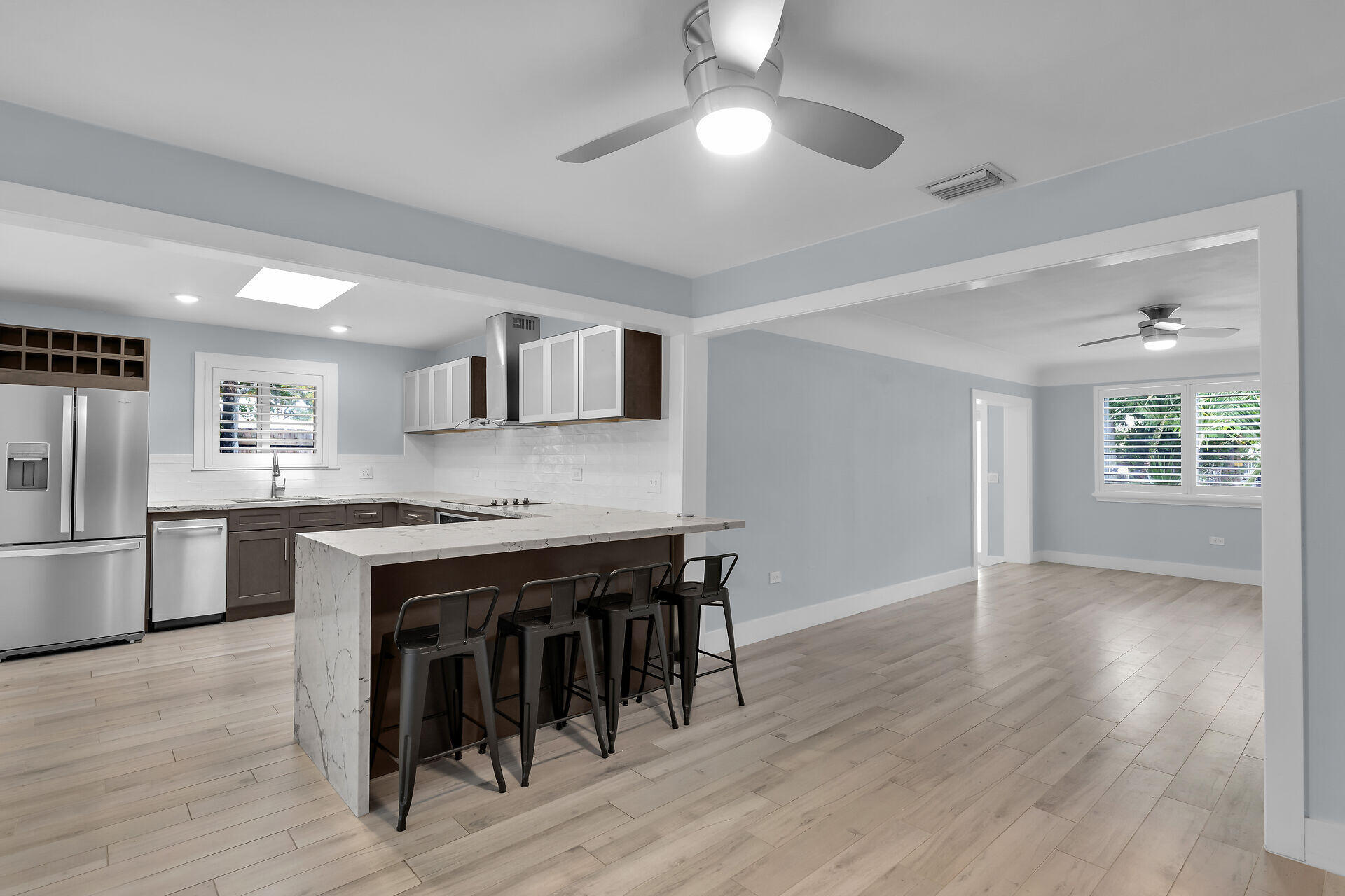 535 Plante Street Key Largo, FL 33037 - Photo 10 of 47 a kitchen with stainless steel appliances granite countertop a stove top oven a sink dishwasher and a refrigerator with wooden floor