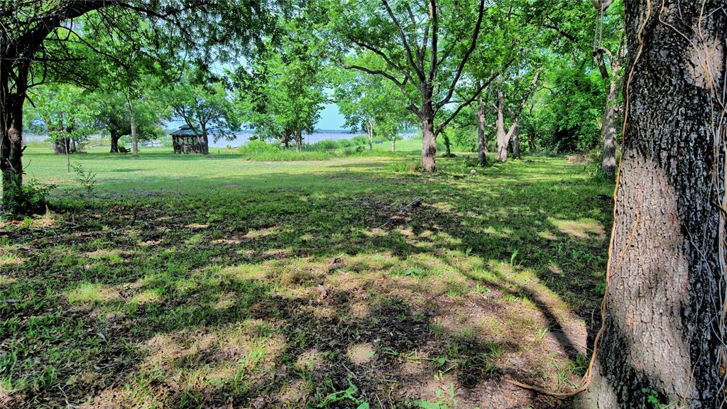 140 Elm Road Nocona, TX 76255 - Photo 3 of 26 a view of a grassy field with trees