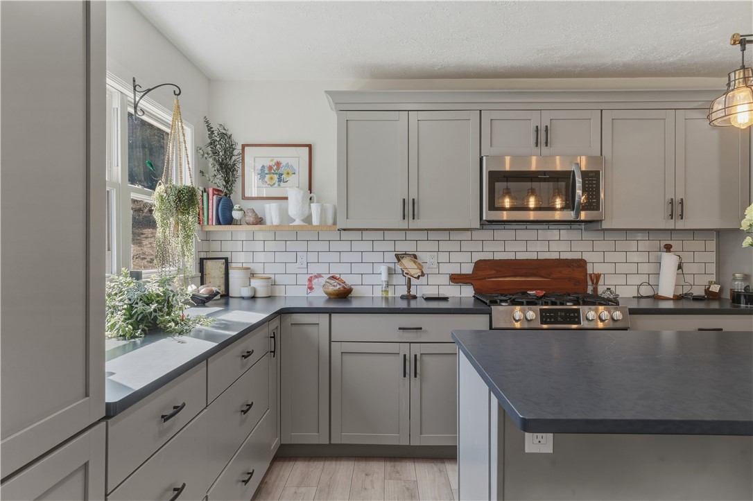 10684 Bear Run Road Corning, NY 14830 - Photo 3 of 32 The kitchen was recently remodeled and all new cabinetry was installed, along with granite counters a nd a subway tile backsplash.