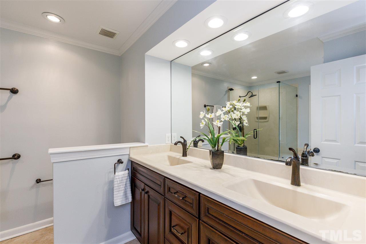 2921 Old Milburnie Road Raleigh, NC 27604 - Photo 12 of 27 a bathroom with a sink and a mirror