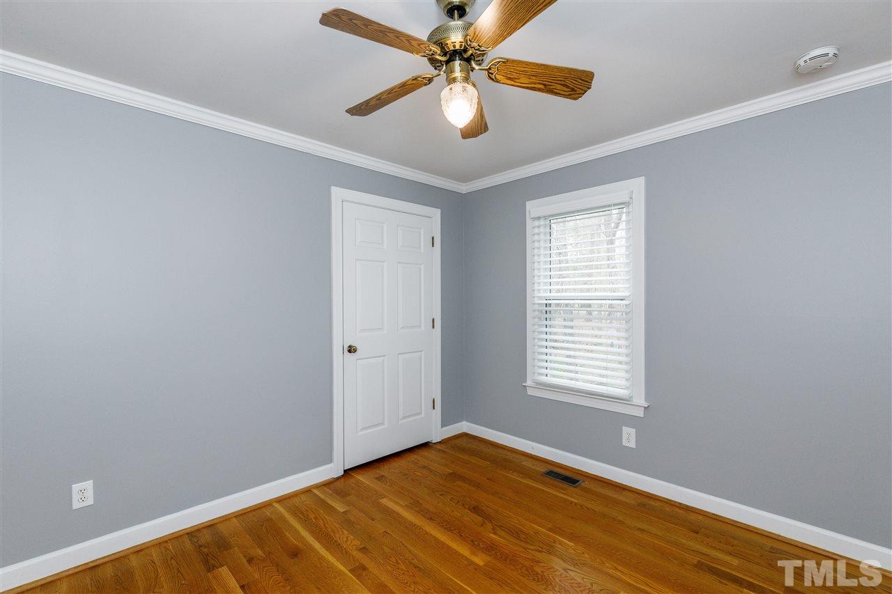 2921 Old Milburnie Road Raleigh, NC 27604 - Photo 14 of 27 a view of an empty room with window and a chandelier fan