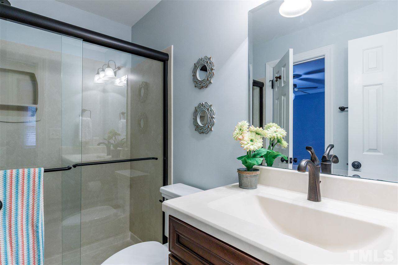 2921 Old Milburnie Road Raleigh, NC 27604 - Photo 15 of 27 a bathroom with a sink and a mirror