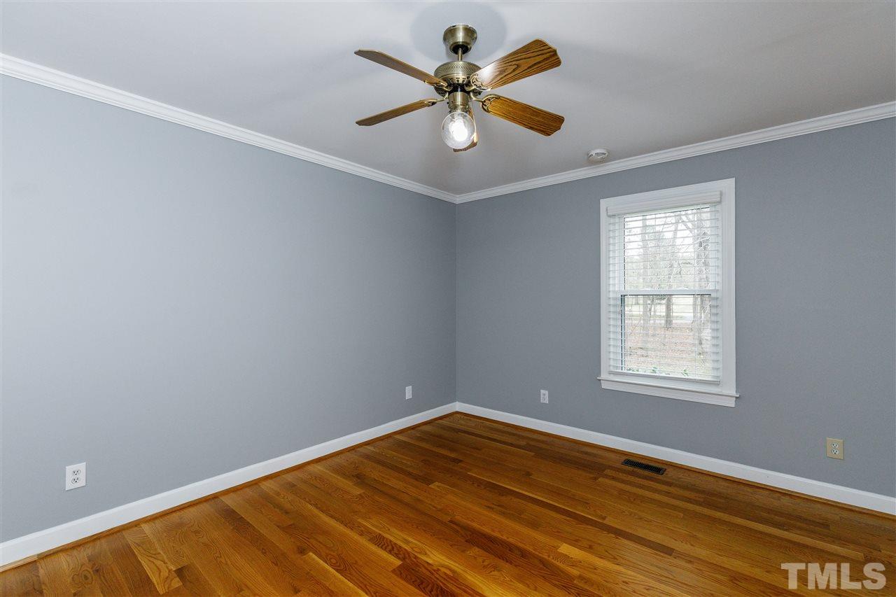 2921 Old Milburnie Road Raleigh, NC 27604 - Photo 16 of 27 wooden floor in an empty room with a window