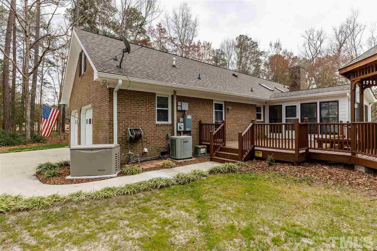 2921 Old Milburnie Road Raleigh, NC 27604 - Photo 18 of 27 a view of backyard with deck and outdoor seating
