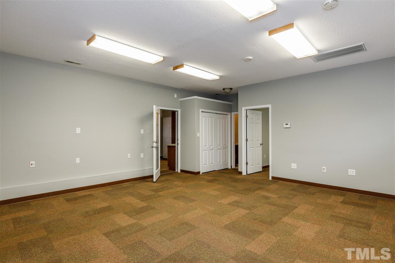 2921 Old Milburnie Road Raleigh, NC 27604 - Photo 21 of 27 an empty room with windows and entrance to other room