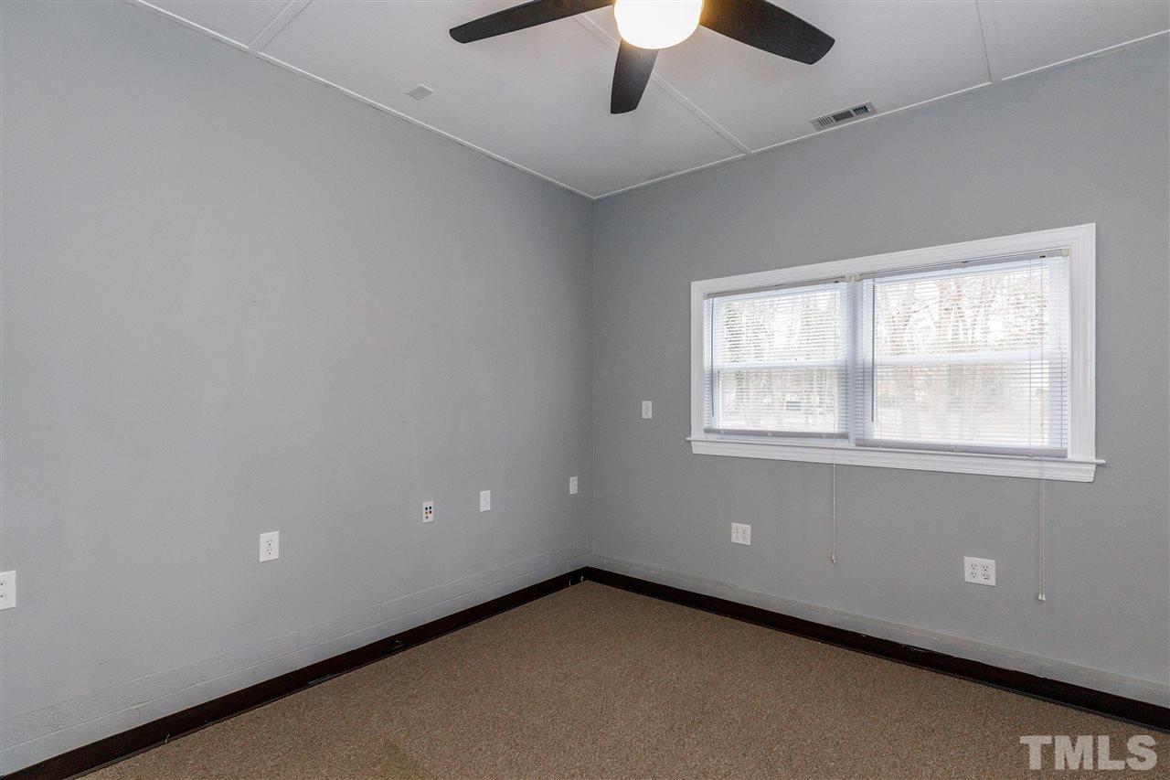 2921 Old Milburnie Road Raleigh, NC 27604 - Photo 26 of 27 an empty room with a window and a ceiling fan