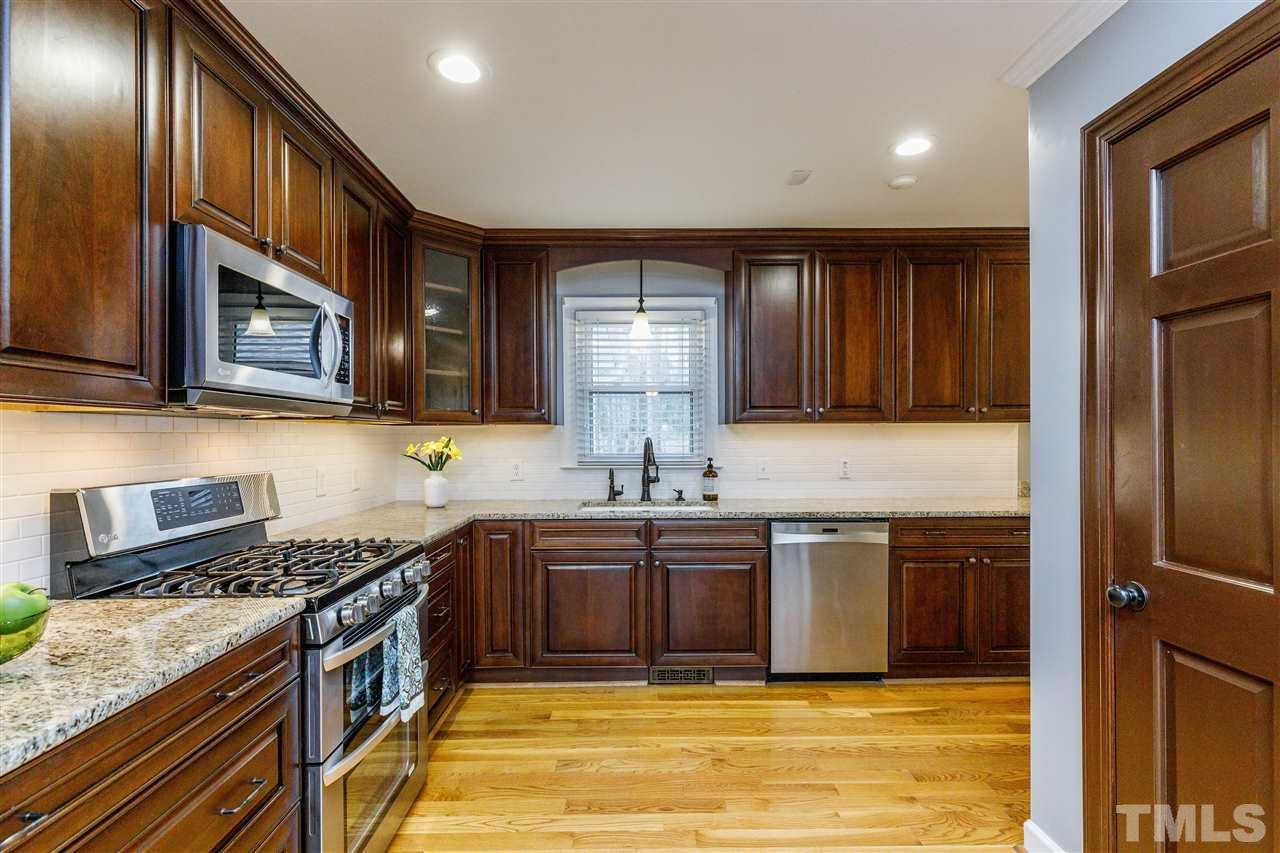 2921 Old Milburnie Road Raleigh, NC 27604 - Photo 5 of 27 a kitchen with stainless steel appliances granite countertop a sink stove and cabinets
