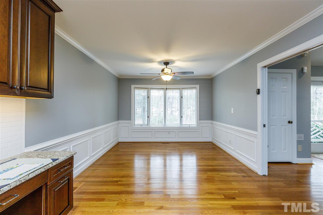 2921 Old Milburnie Road Raleigh, NC 27604 - Photo 7 of 27 a view of empty room with wooden floor and fan