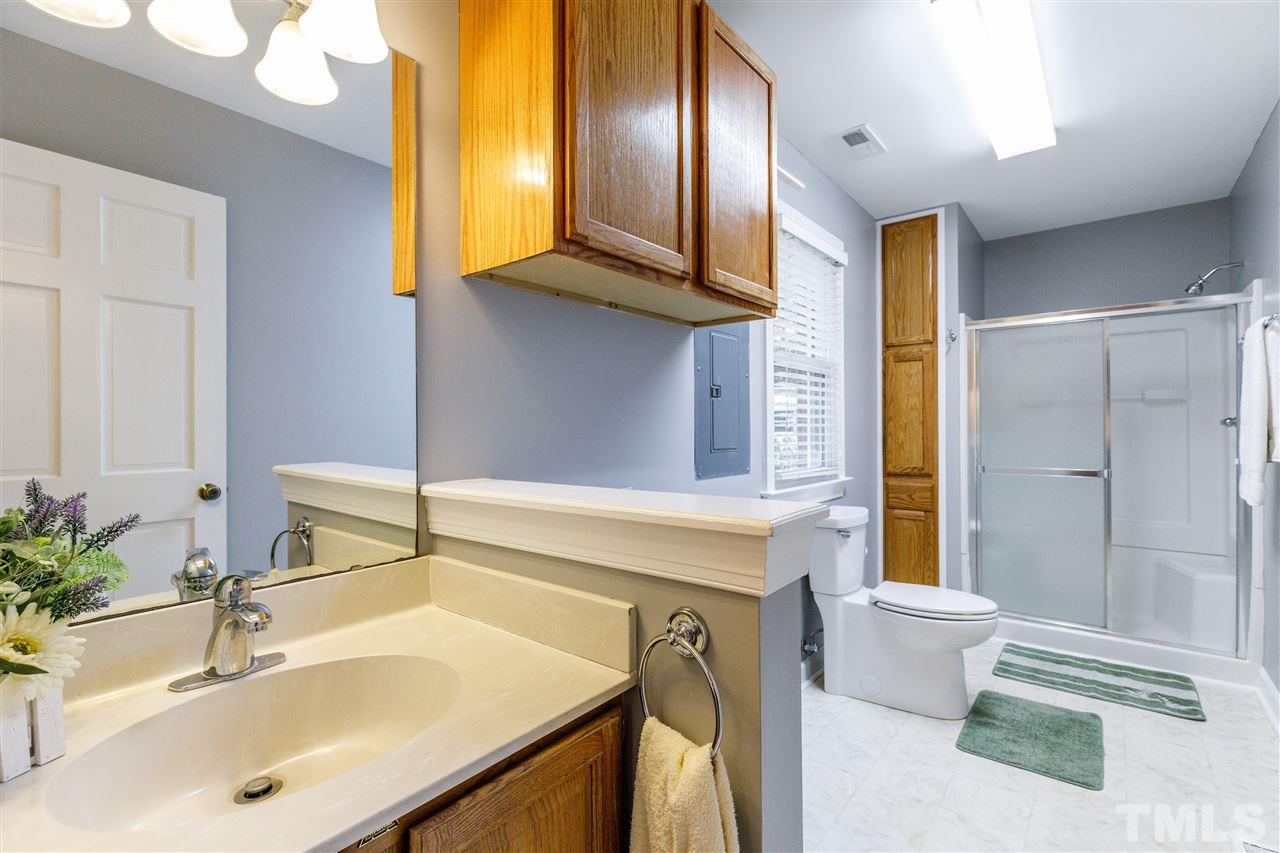 2921 Old Milburnie Road Raleigh, NC 27604 - Photo 8 of 27 a bathroom with a sink and a mirror