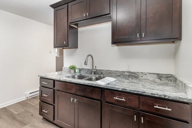 a kitchen with granite countertop stainless steel appliances sink and cabinets