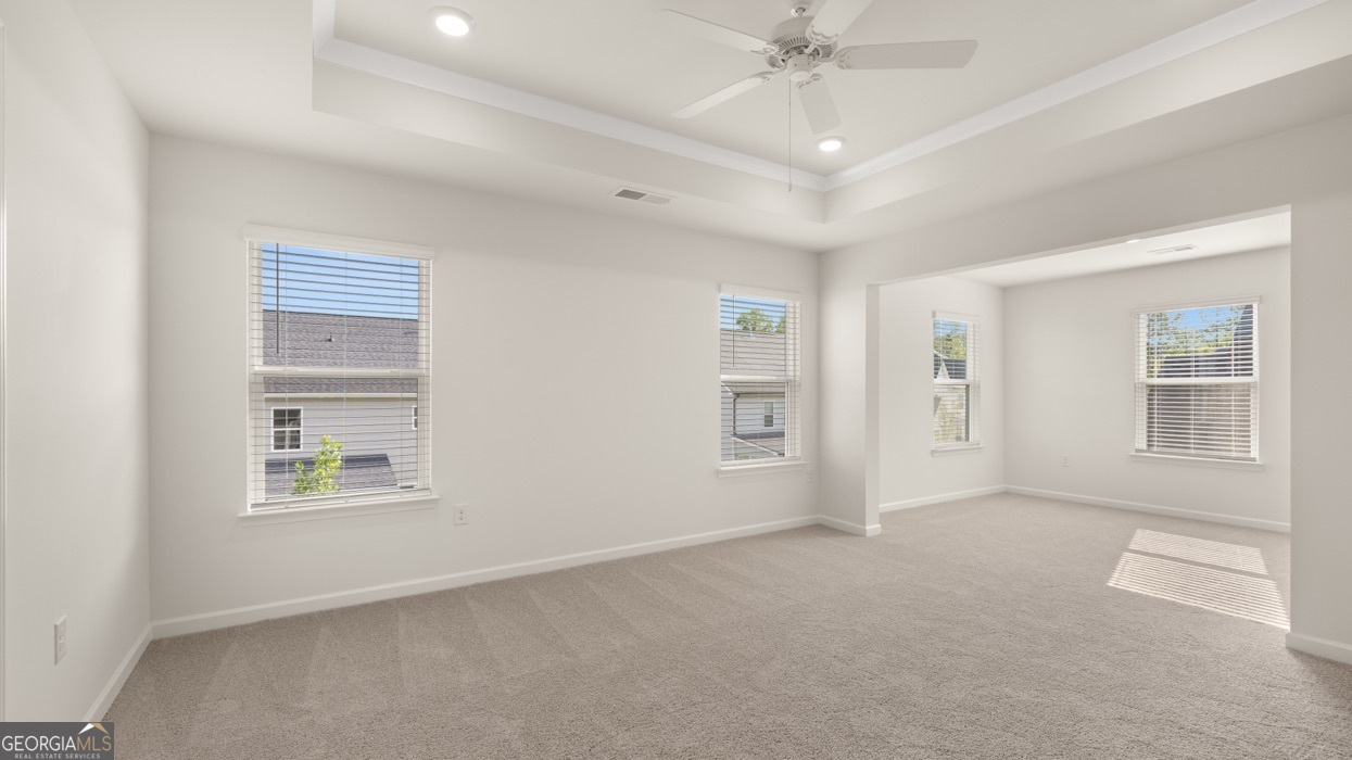 13604 Whitman Lane Covington, GA 30014 - Photo 12 of 52 an empty room with windows and fan