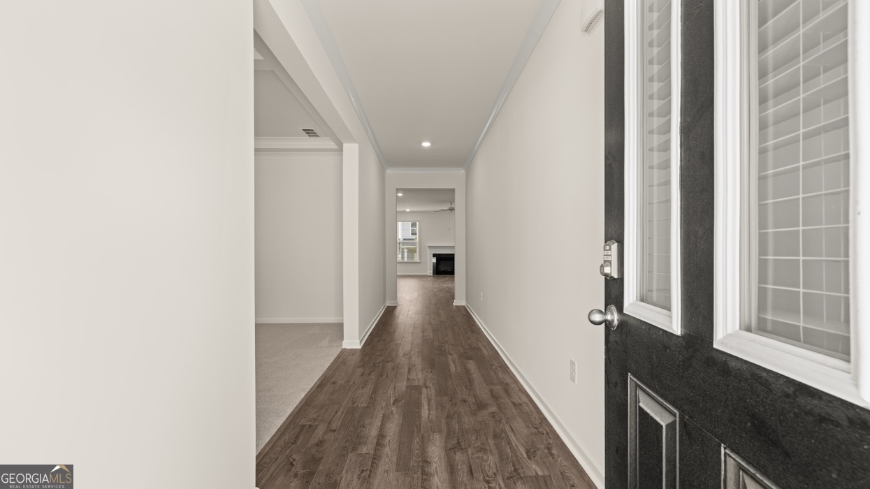 13604 Whitman Lane Covington, GA 30014 - Photo 17 of 52 a view of a hallway with wooden floor and staircase