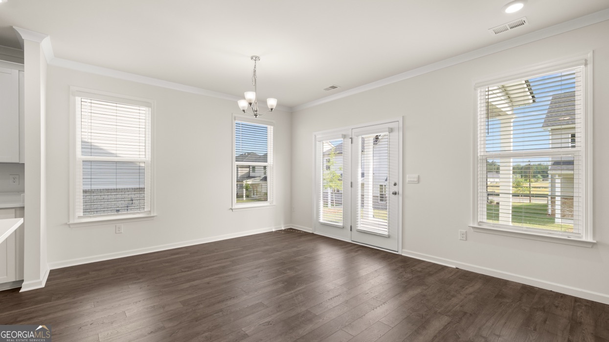 13604 Whitman Lane Covington, GA 30014 - Photo 26 of 52 a view of an empty room with wooden floor and a window