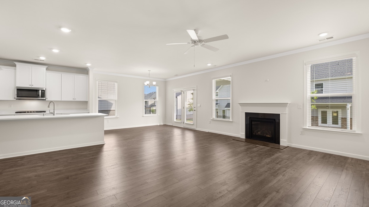 13604 Whitman Lane Covington, GA 30014 - Photo 31 of 52 a view of an empty room with wooden floor and a kitchen
