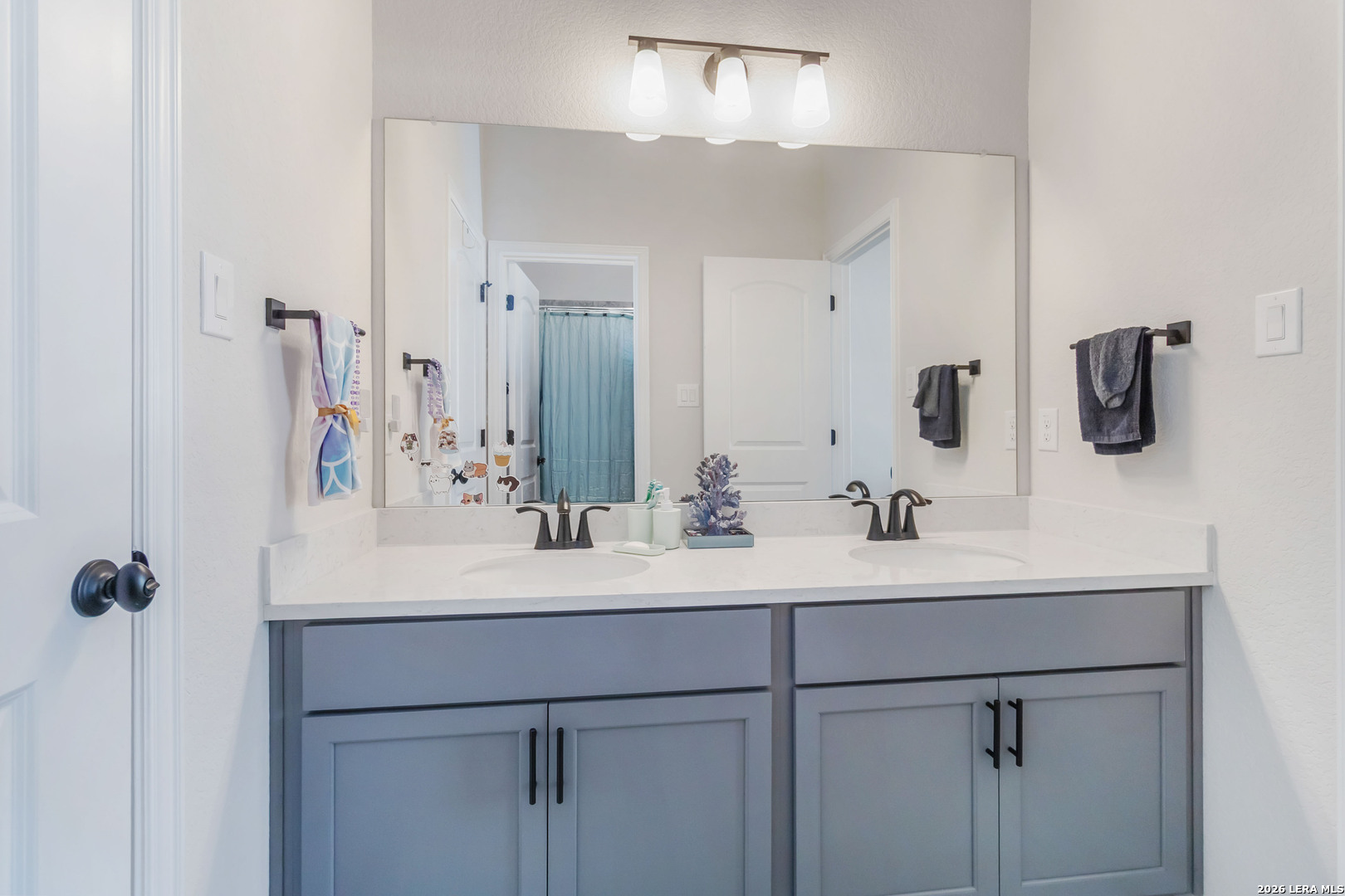 8024 Trail Grant Schertz, TX 78154 - Photo 11 of 20 a bathroom with a sink vanity and mirror