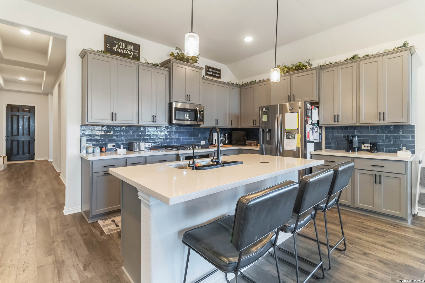 8024 Trail Grant Schertz, TX 78154 - Photo 5 of 20 a kitchen with kitchen island a sink stove and refrigerator