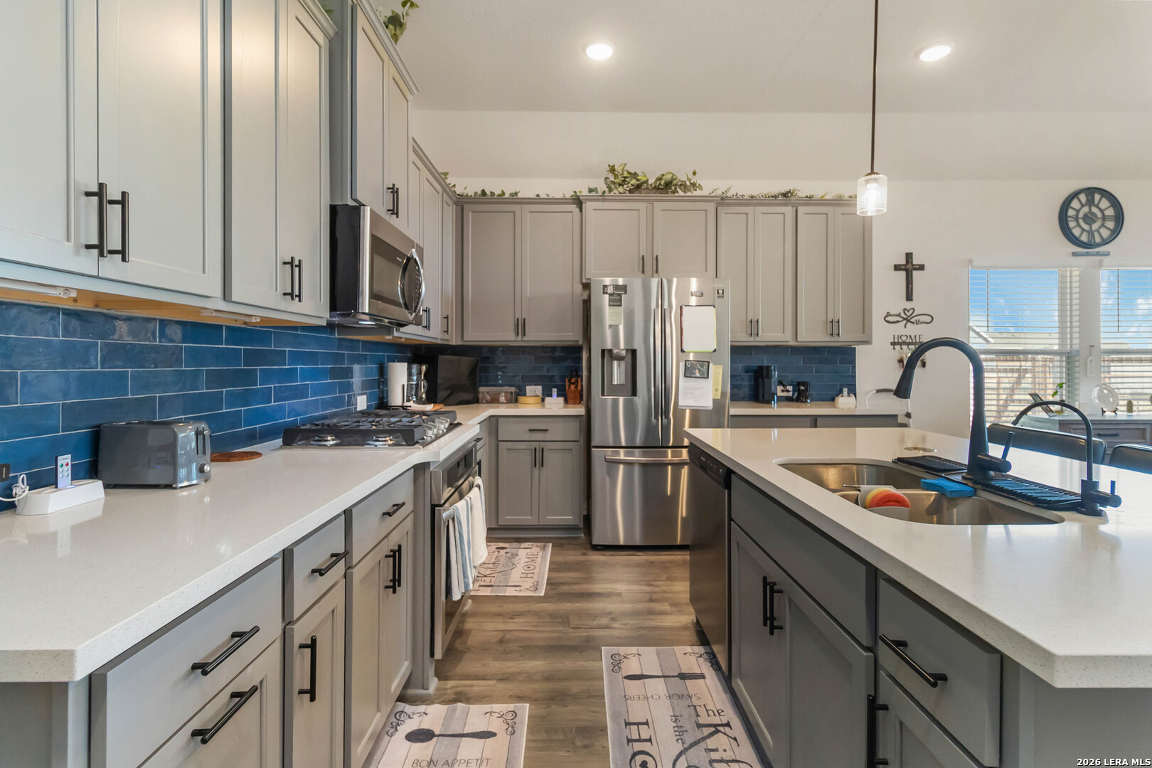 8024 Trail Grant Schertz, TX 78154 - Photo 7 of 20 a kitchen with stainless steel appliances granite countertop a sink stove and refrigerator