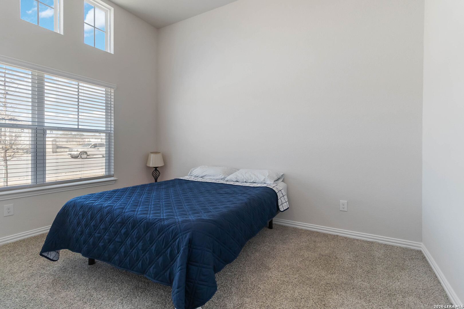8024 Trail Grant Schertz, TX 78154 - Photo 8 of 20 a bedroom with a bed and a window