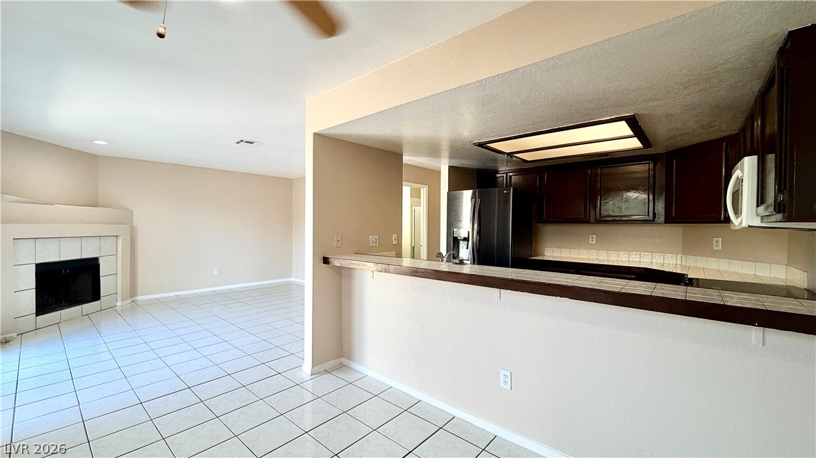 6250 West Flamingo Road, Unit 4 Las Vegas, NV 89103 - Photo 10 of 45 This living space seamlessly connects to the kitchen, creating an inviting atmosphere.