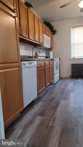 a kitchen with white cabinets and white appliances