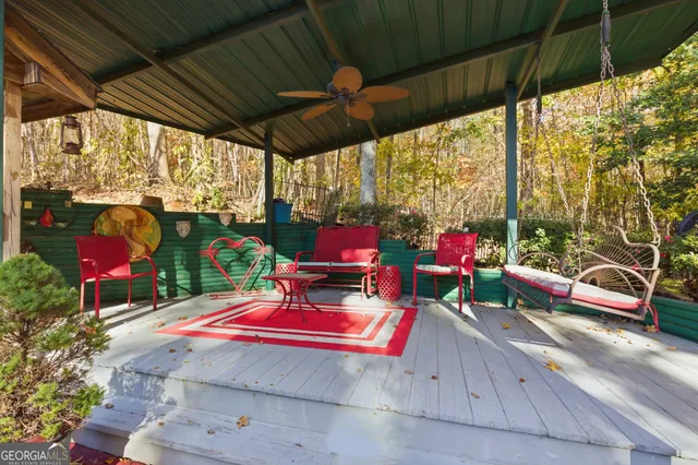 a view of a patio with dining table and chairs