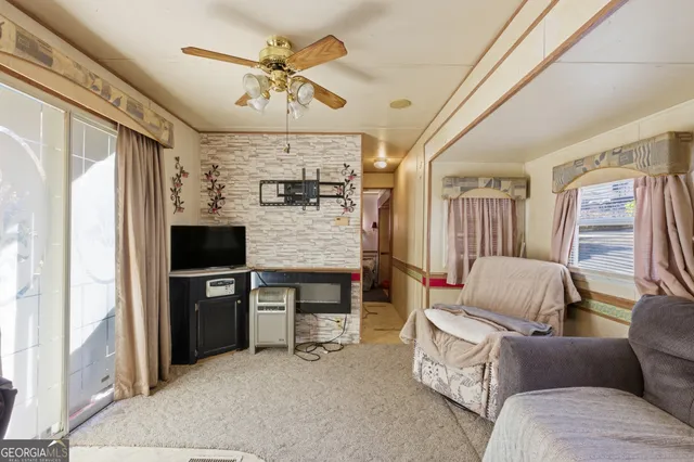 a living room with furniture and a flat screen tv