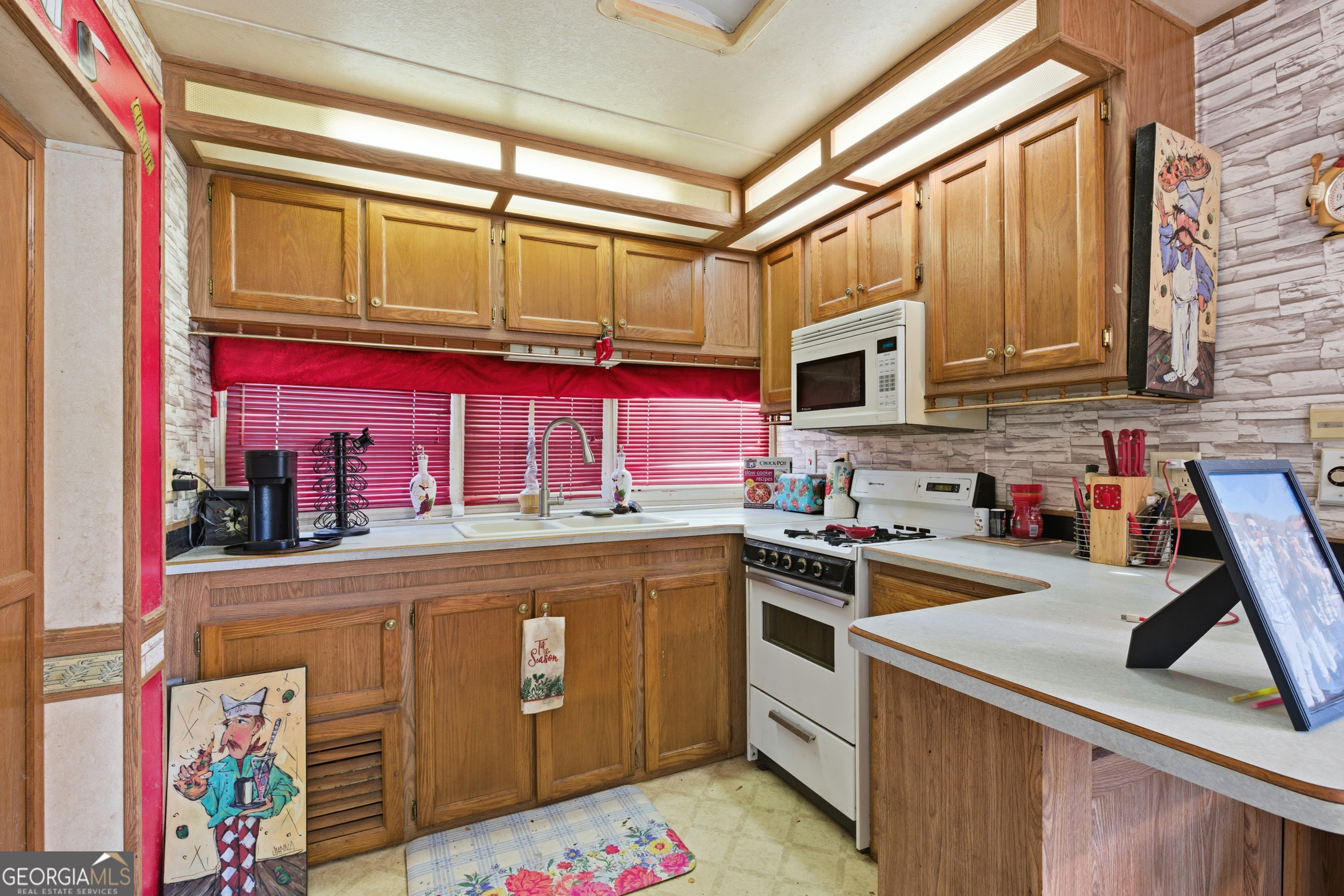 105 Holiday Loop Cleveland, GA 30528 - Photo 27 of 41 a kitchen with stainless steel appliances granite countertop a stove and a microwave