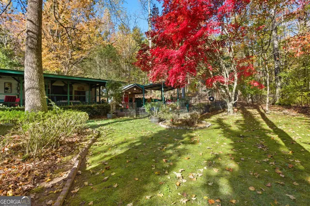 a backyard of a house with table and chairs