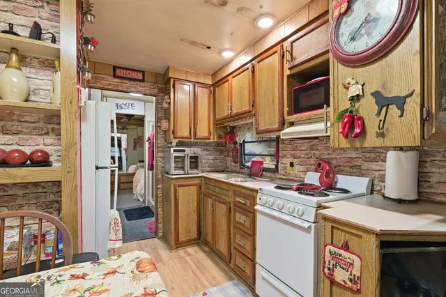 a utility room with stainless steel appliances kitchen island granite countertop a stove a sink and dishwasher