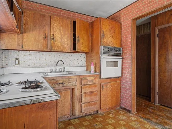 a kitchen with a stove a sink and cabinets