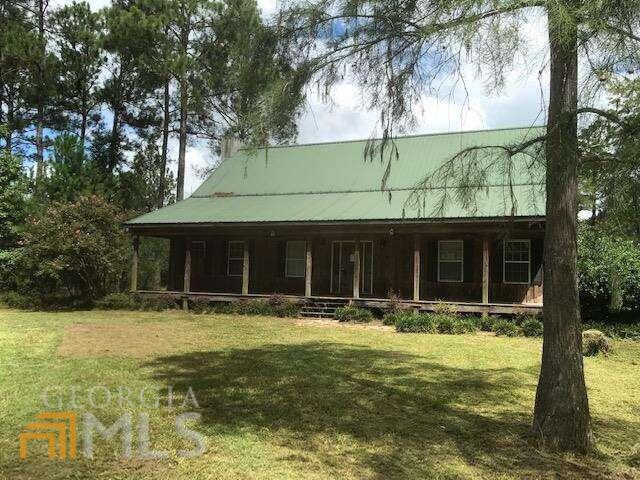 242 Lumpkin Road West Leesburg, GA 31763 - Photo 1 of 1 a front view of house with yard and trees in the background