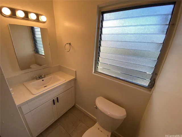 a bathroom with a sink a toilet and mirror