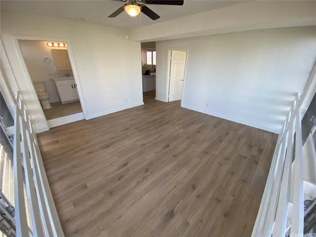 wooden floor in an empty room with a mirror