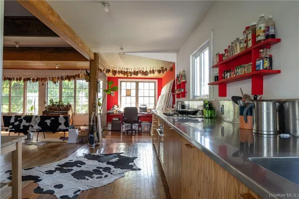 a living room with lots of furniture and a large window