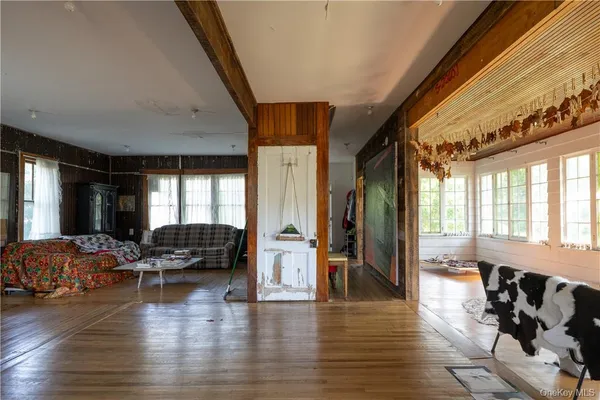 a living room with furniture window and wooden floor