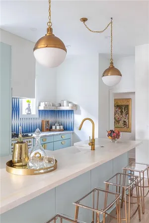 a kitchen with a table a chandelier and living room view