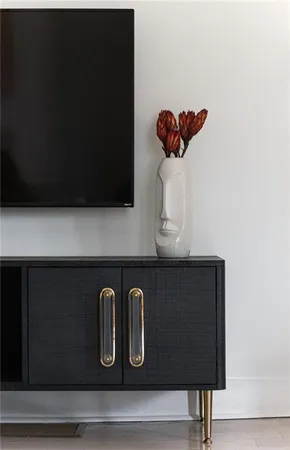 a view of a sink with wooden cabinets