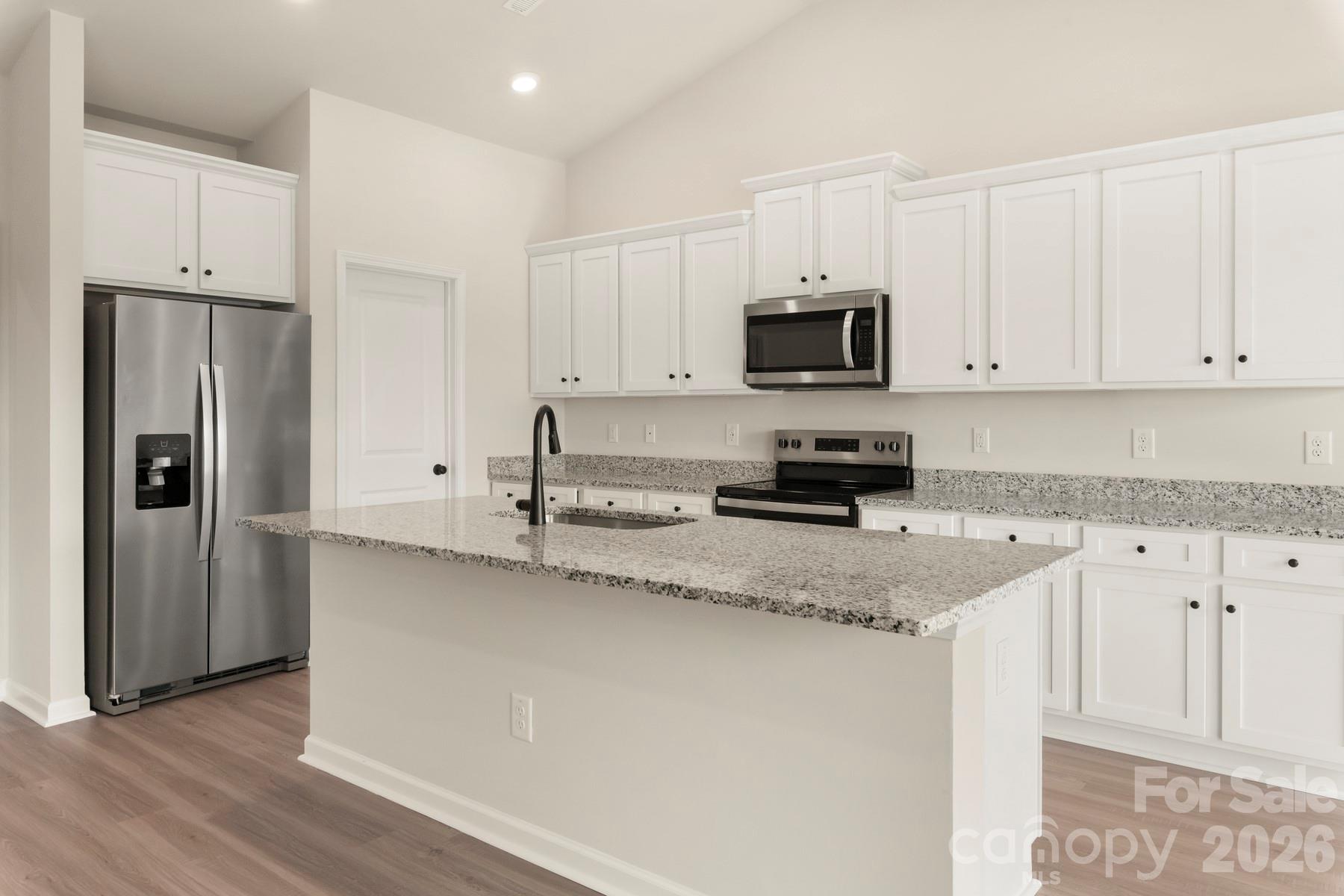 285 Limestone Terrace Salisbury, NC 28146 - Photo 8 of 22 a kitchen with granite countertop white cabinets and stainless steel appliances