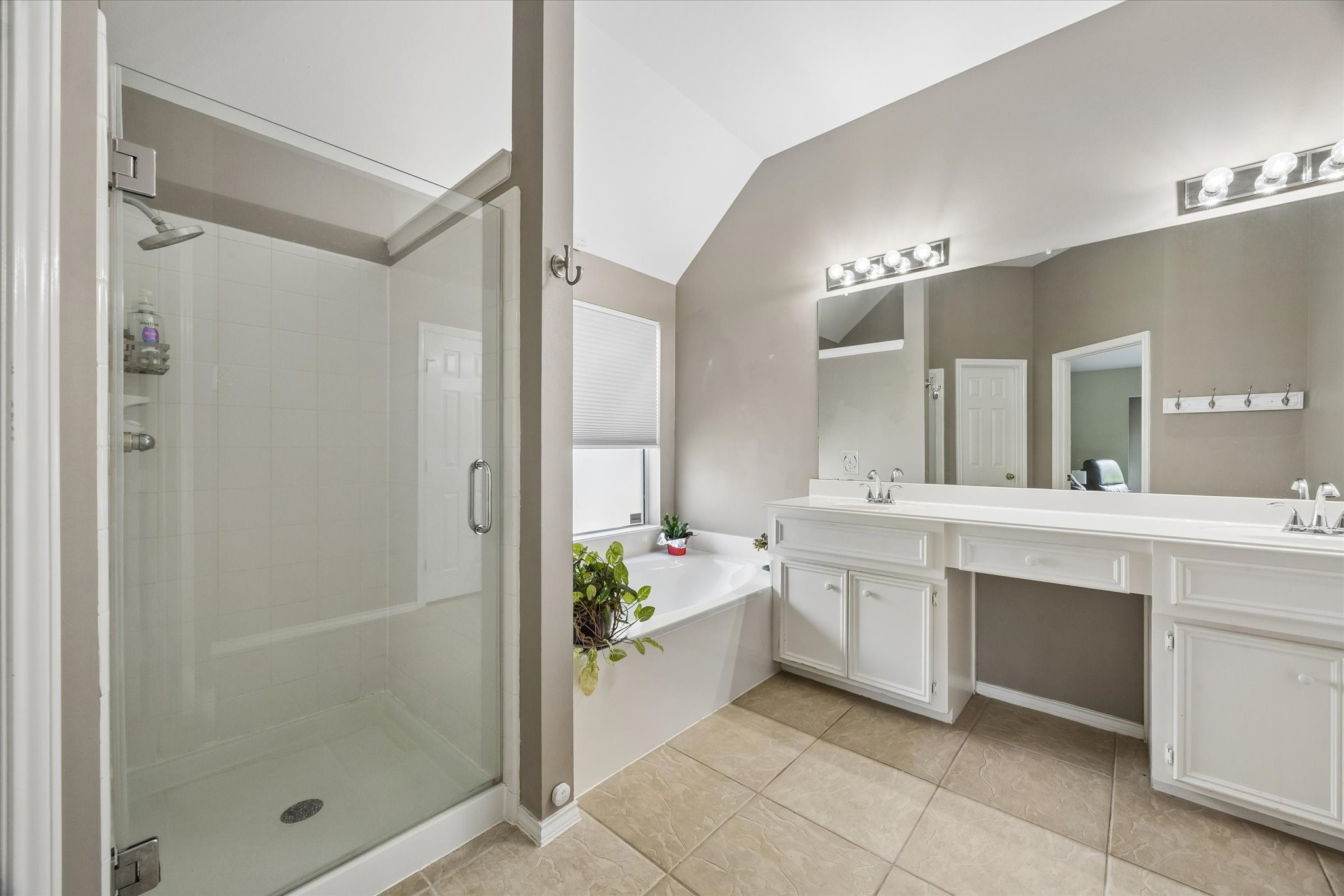 3118 Valley Court Manvel, TX 77578 - Photo 14 of 38 This bathroom features a spacious walk-in shower, a large soaking tub, and a dual-sink vanity with ample counter space. The neutral color scheme and tile flooring create a clean and modern look.