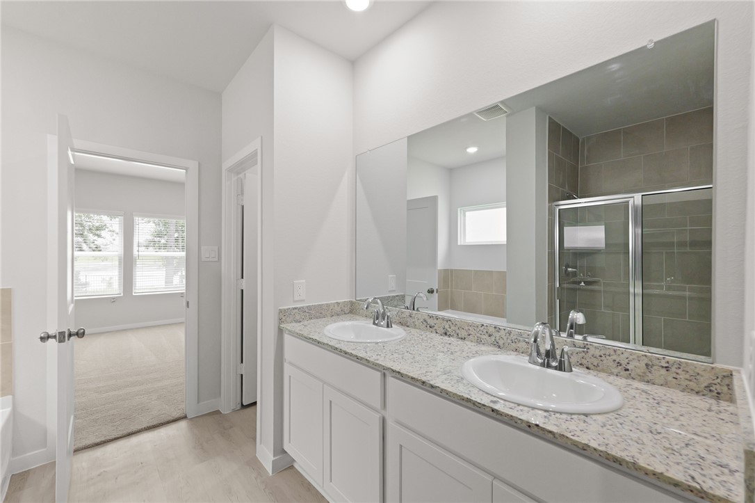 4414 Albritton Avenue Bryan, TX 77801 - Photo 27 of 30 a bathroom with a granite countertop sink and a mirror