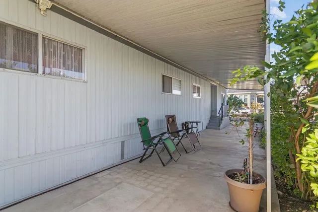 a view of a patio with table and chairs and potted plants