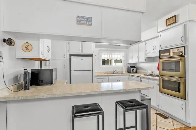 a kitchen with stainless steel appliances a stove microwave and refrigerator