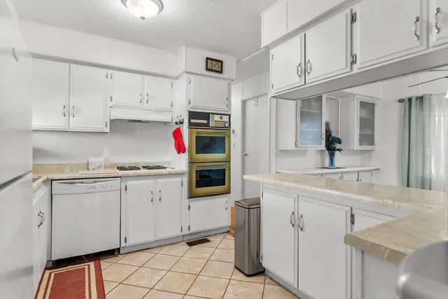 a kitchen with stainless steel appliances granite countertop a sink and cabinets