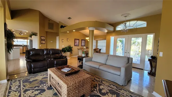 a living room with furniture ceiling fan and a rug