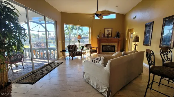 a living room with furniture large window and a fireplace