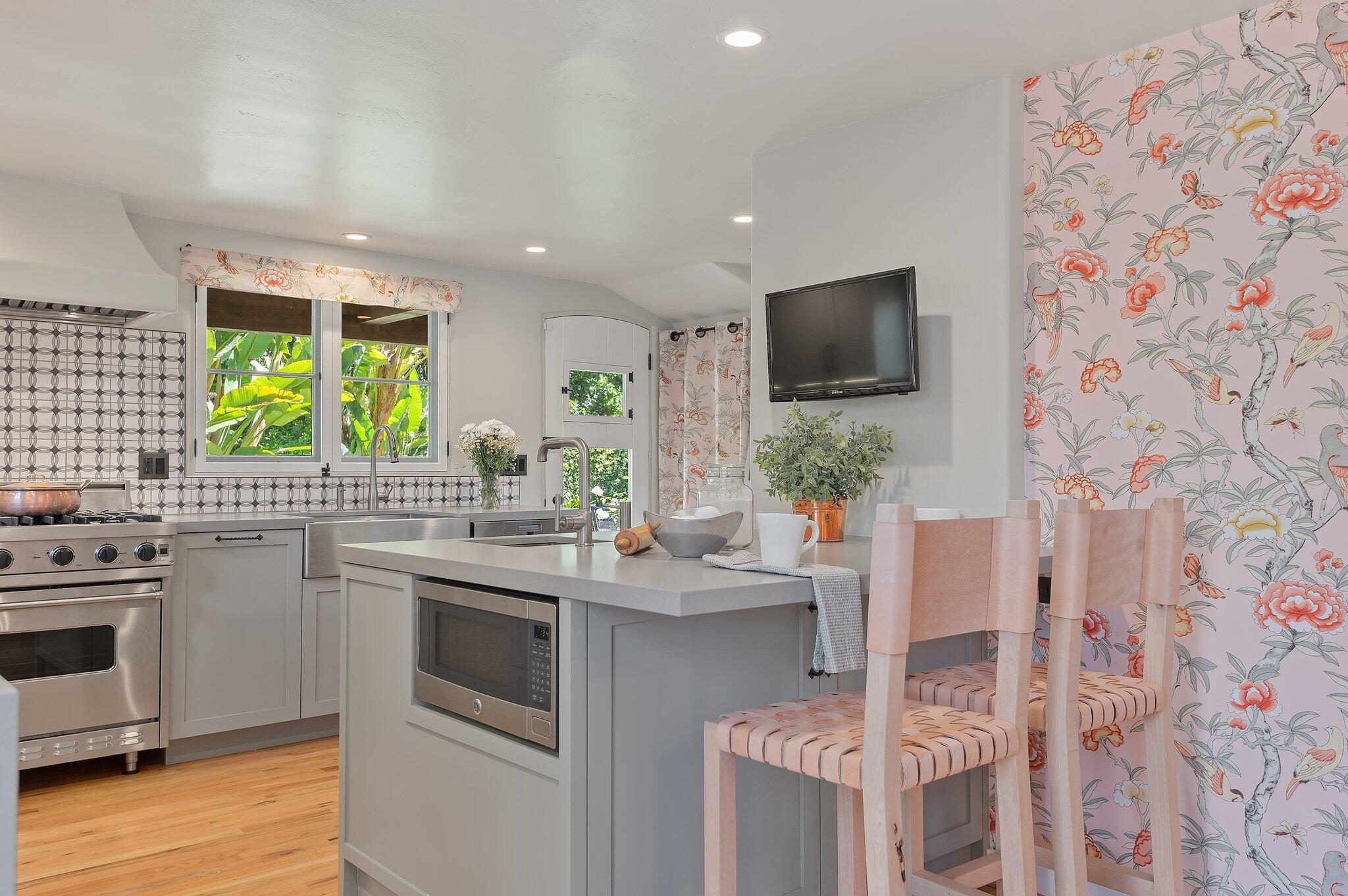 1520 Lingate Lane Montecito, CA 93108 - Photo 13 of 38 a kitchen with stainless steel appliances kitchen island granite countertop a sink and wooden cabinets