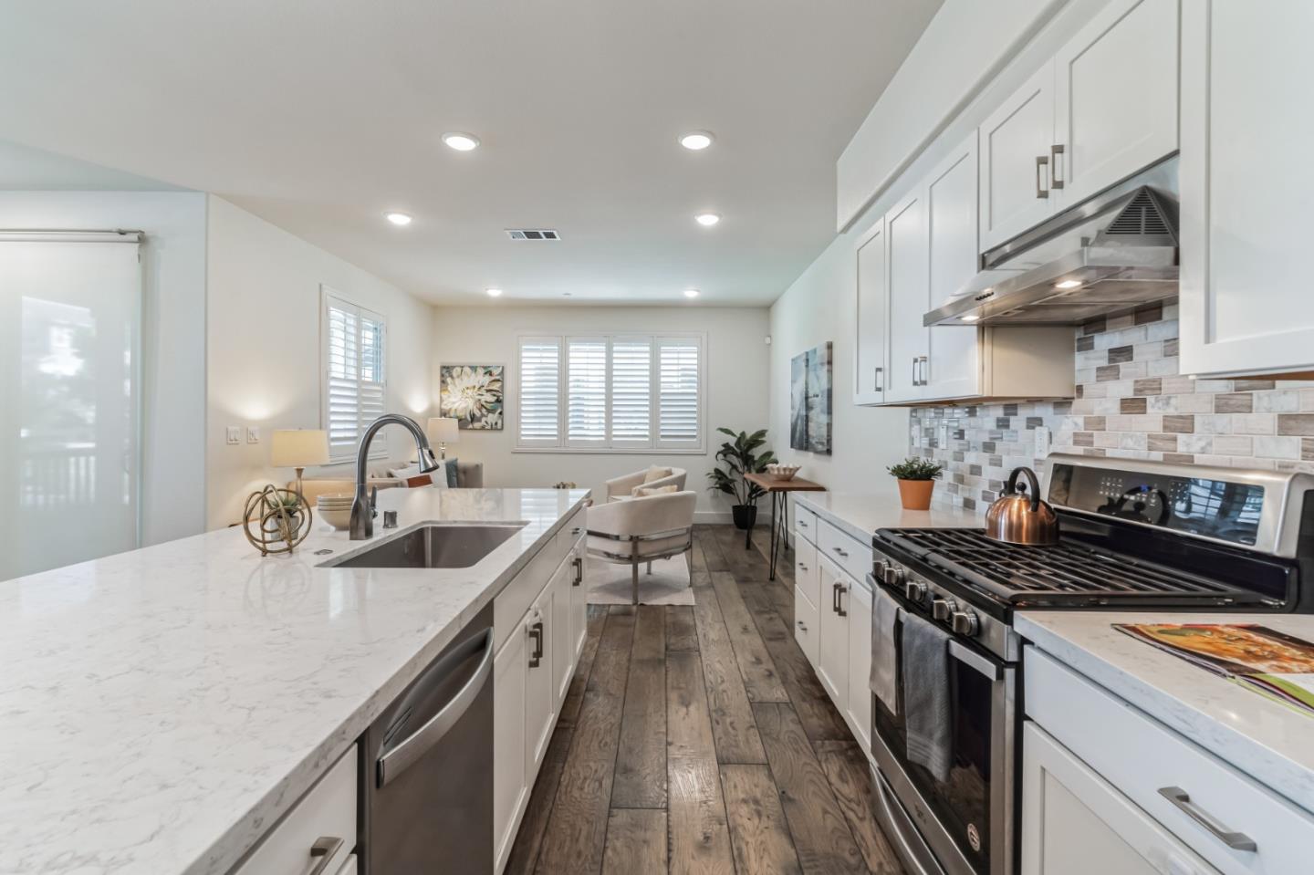 37540 Breakers Road Newark, CA 94560 - Photo 6 of 22 a kitchen with counter top space a sink a stove and cabinets