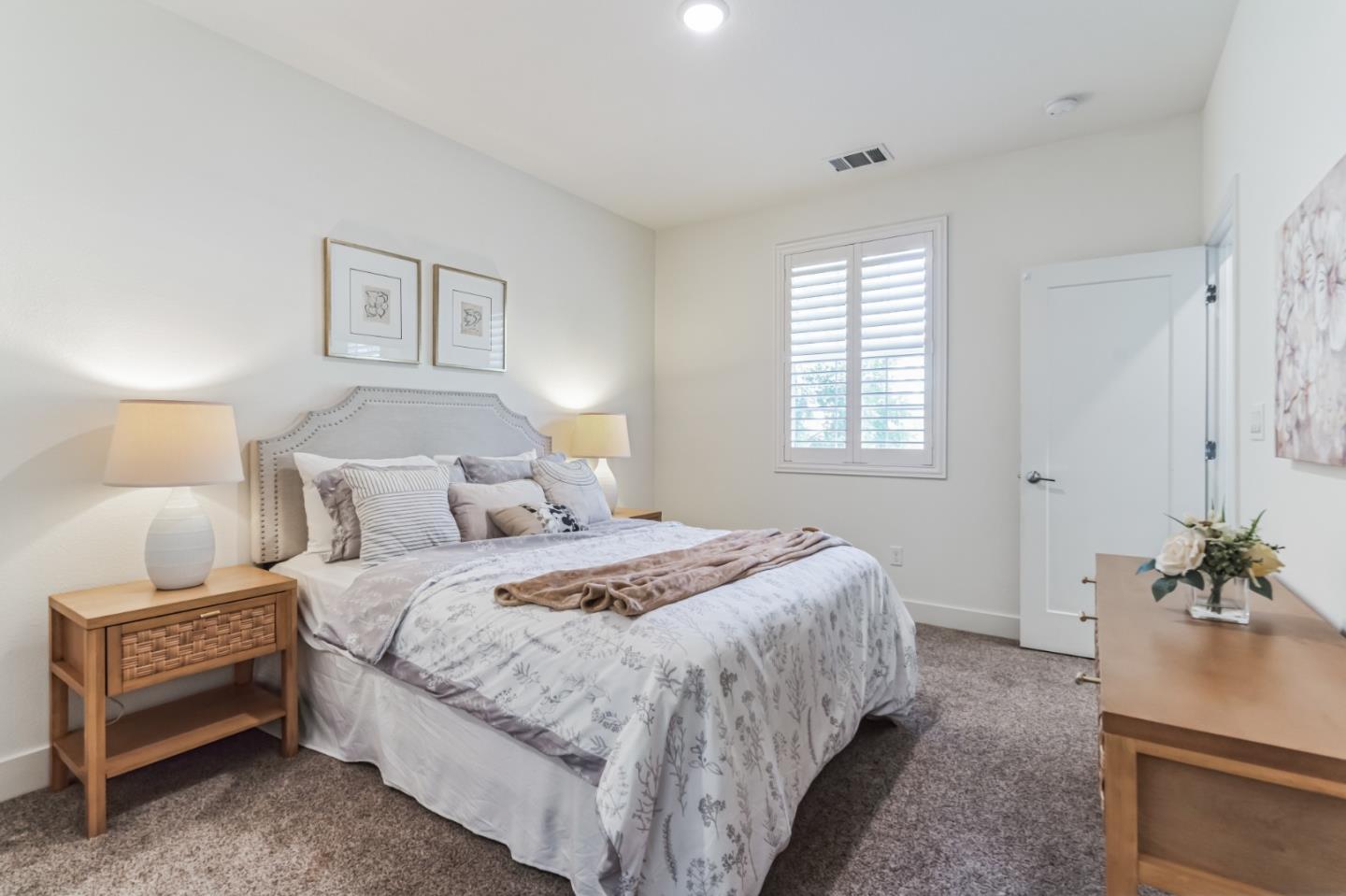 37540 Breakers Road Newark, CA 94560 - Photo 9 of 22 a bedroom with bed and a potted plant