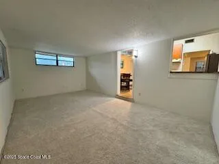 an empty room with windows and cabinet